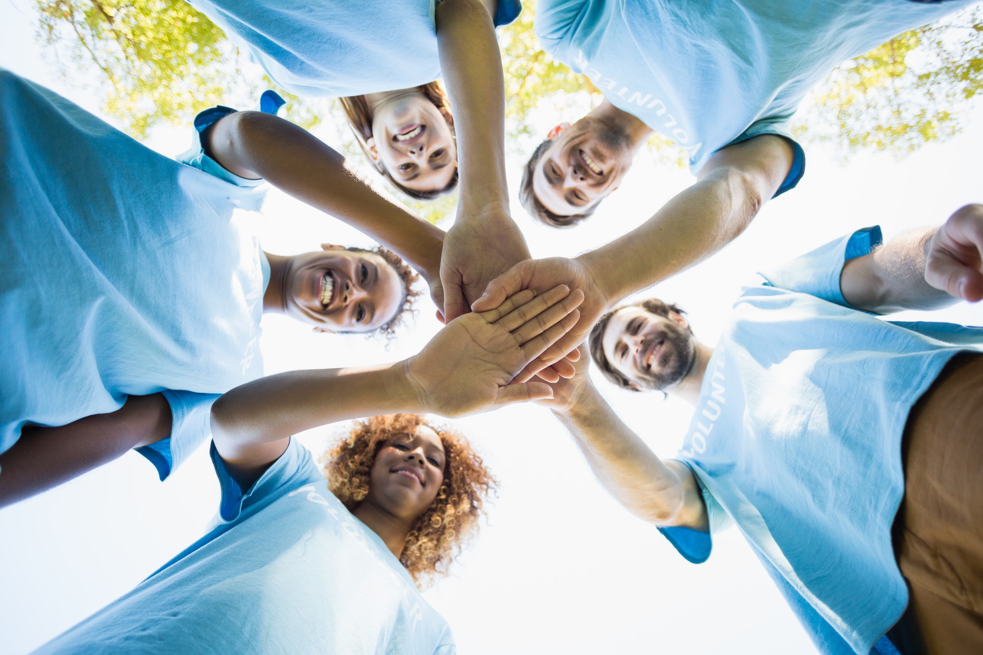 Group of Volunteers Forming a Huddle