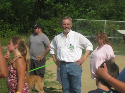 3 individuals and a dog enjoying community day