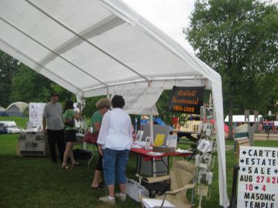 individuals shopping in the tent at community day