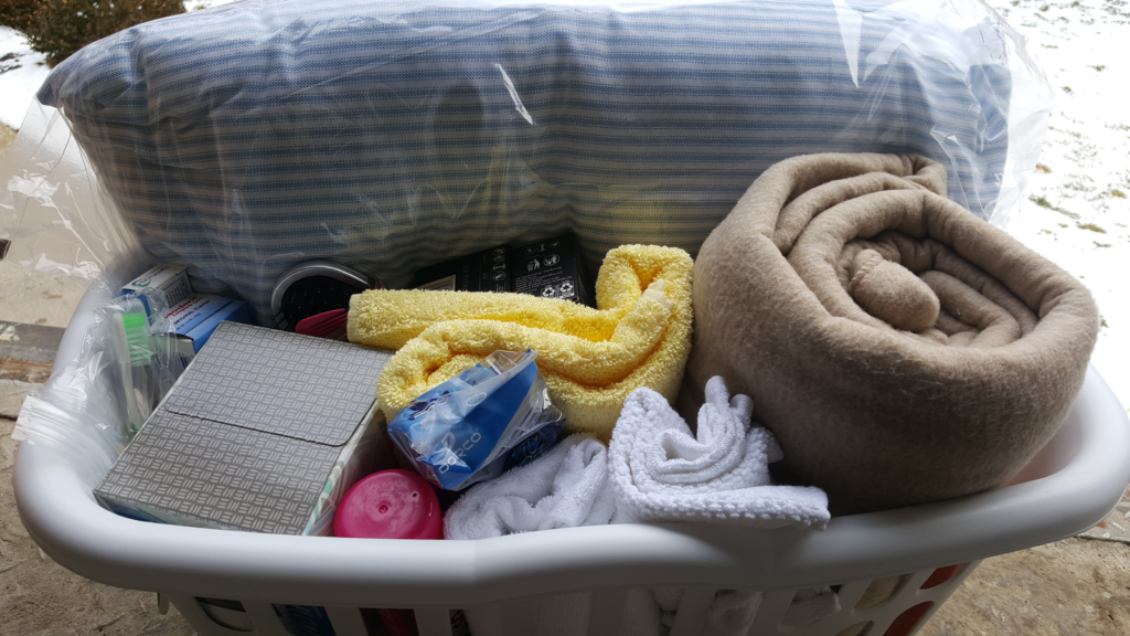 A close view of a laundry basket with towels, washcloths and necessities needed for the Battered Women's Shelter